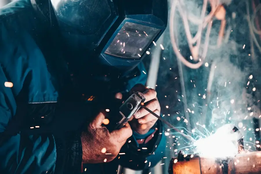 Engineer working on pipework under a sink